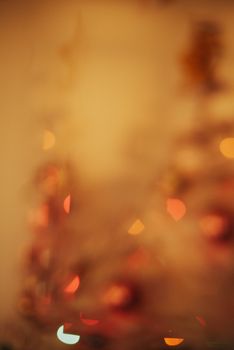 Blurred view of Christmas tree lights, creating a festive and warm ambiance for the holidays.