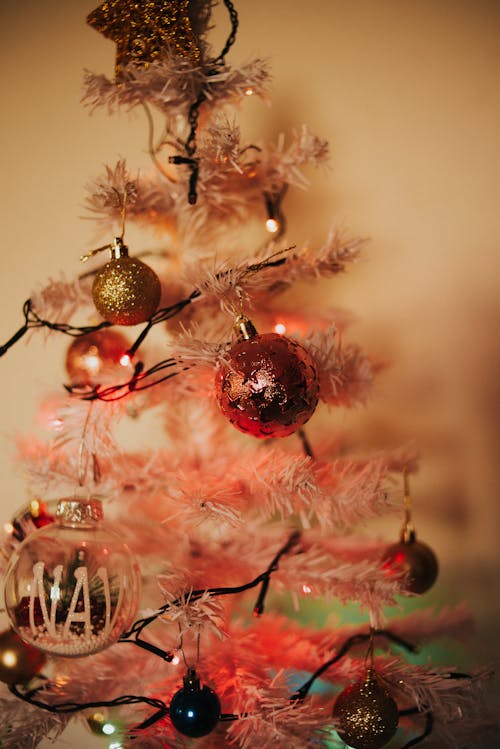 Close-up of a White Christmas Tree with Lights and Baubles 