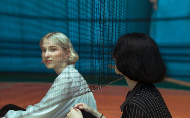 Women Sitting By Net