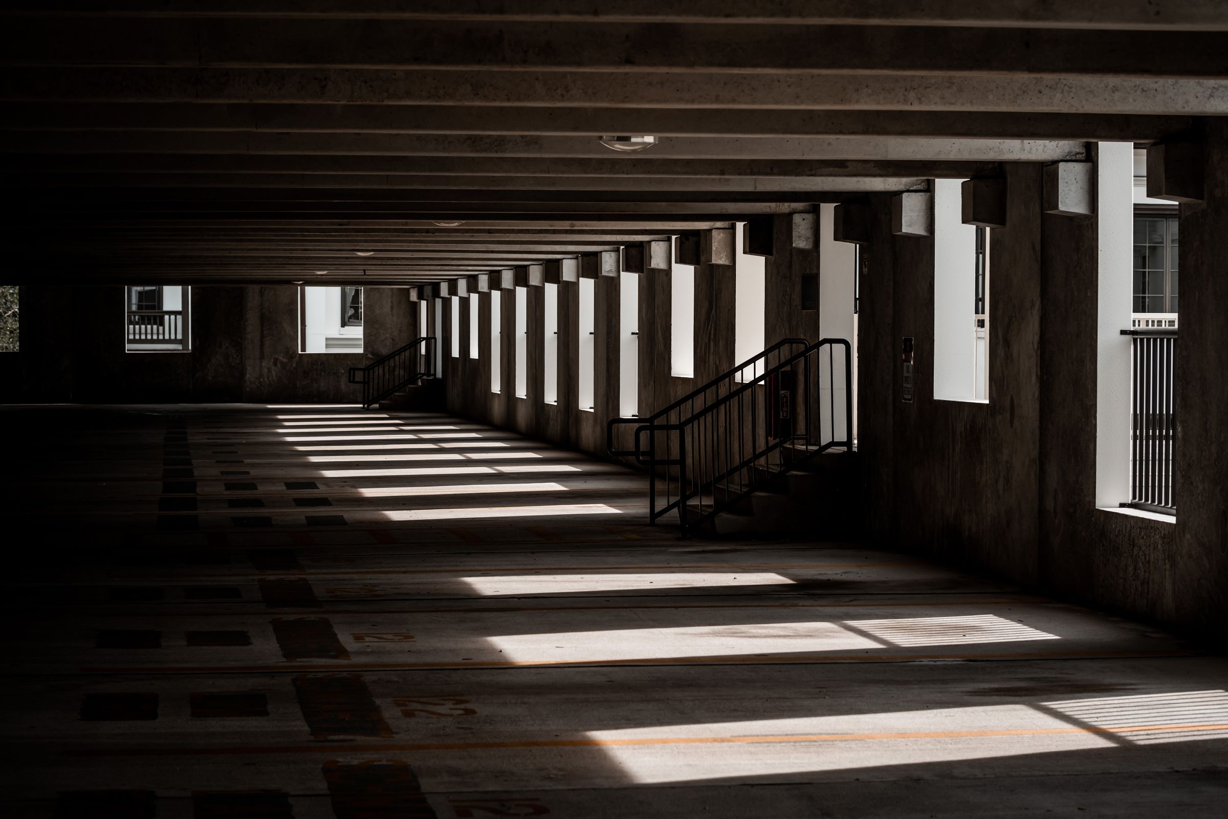Shaded covered parking garage that protects parked cars from direct summer sun