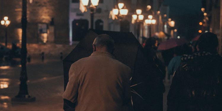 A Man Holding An Umbrella 