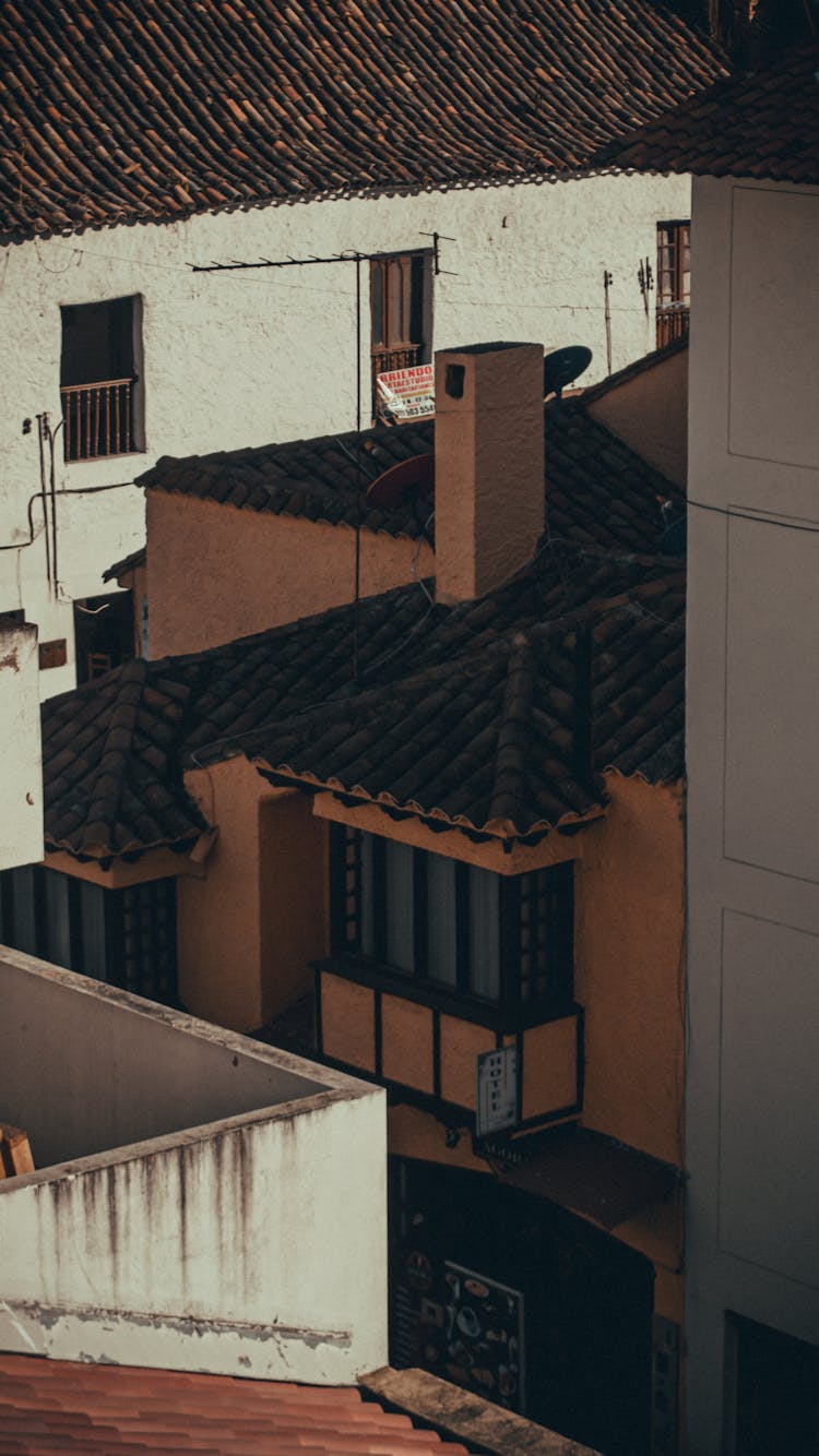 Chimney Above The Tiles Roof Of A Hotel Building