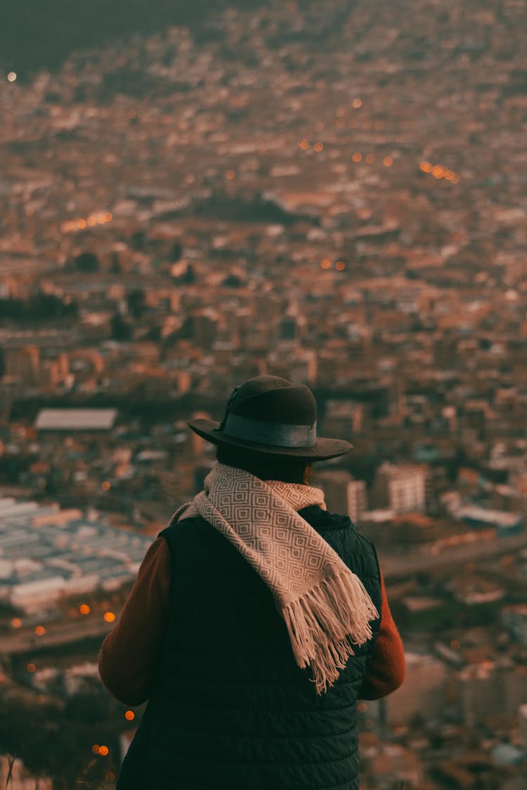 Person In Hat And City Behind