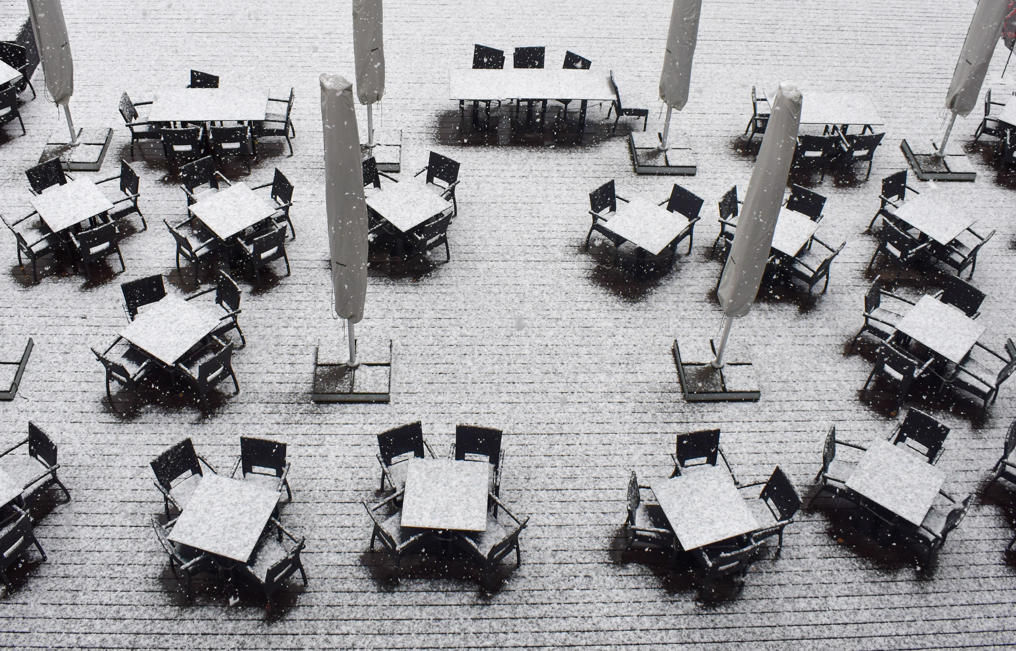 Aerial view of snow-covered outdoor tables and chairs in Esch-sur-Alzette.