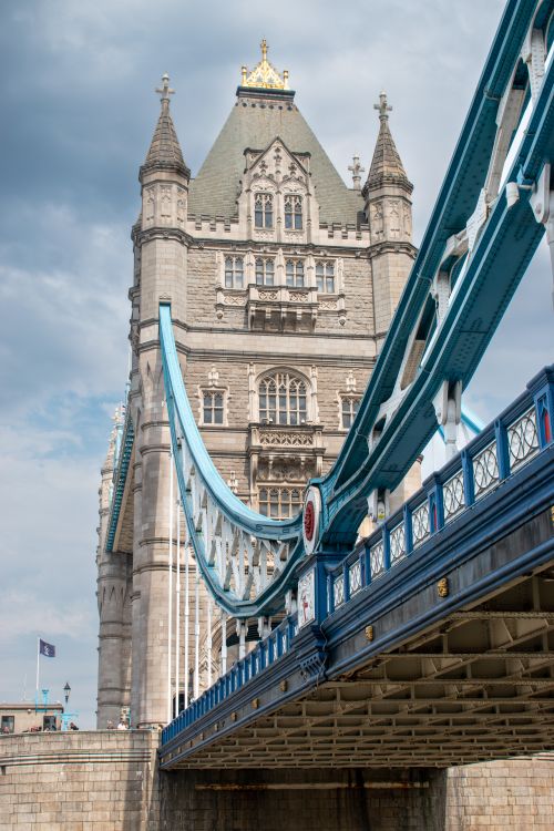 Free A striking view of the iconic Tower Bridge in London showcasing its architectural grandeur against a cloudy sky. Stock Photo