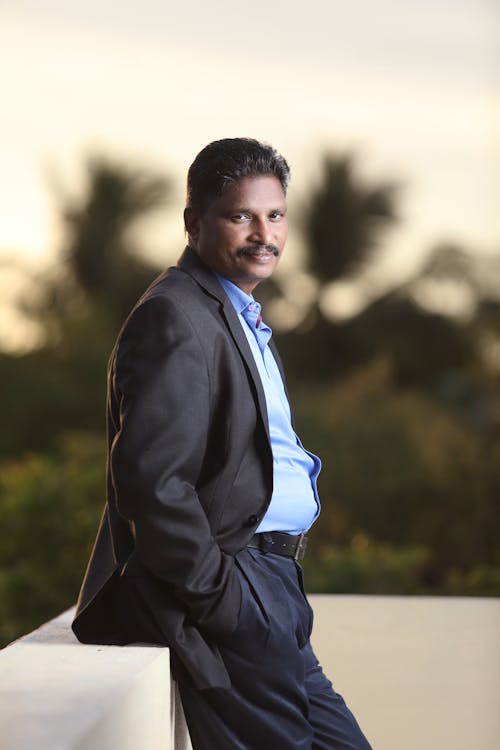 Man Wearing Black Suit Over His Blue Shirt