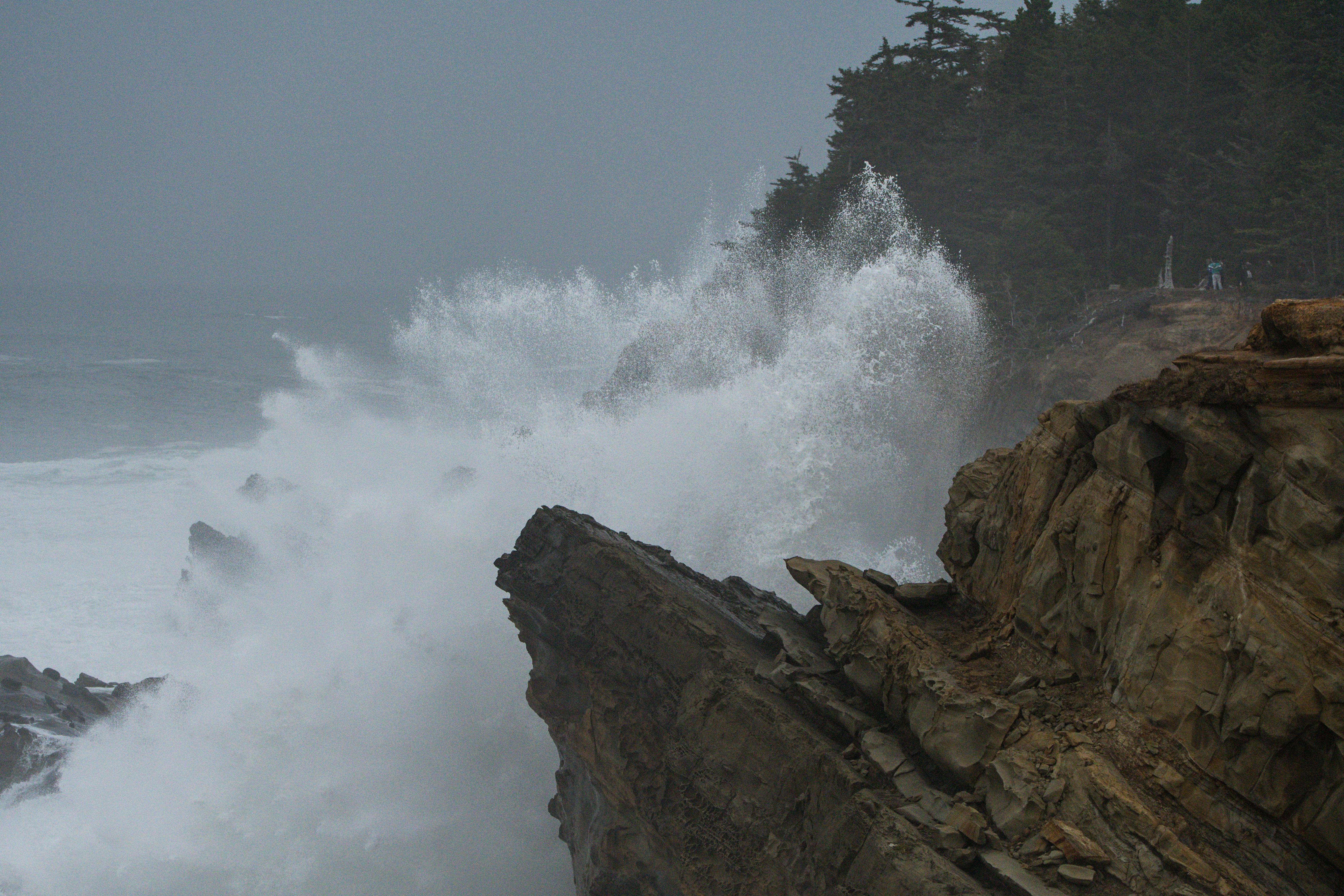 photograph of ocean waves crashing on rocks