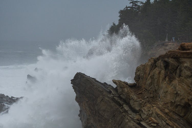 Photograph Of Ocean Waves Crashing On Rocks