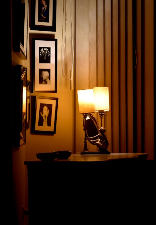 Electric Lamp and a Mirror Standing on a Table in a Room 