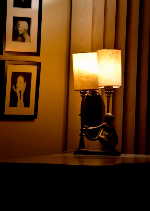 Electric Lamp and a Mirror Standing on a Table in a Room 