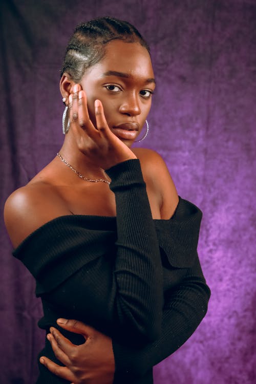 Photo of a Woman Posing with Her Hand on Her Cheek