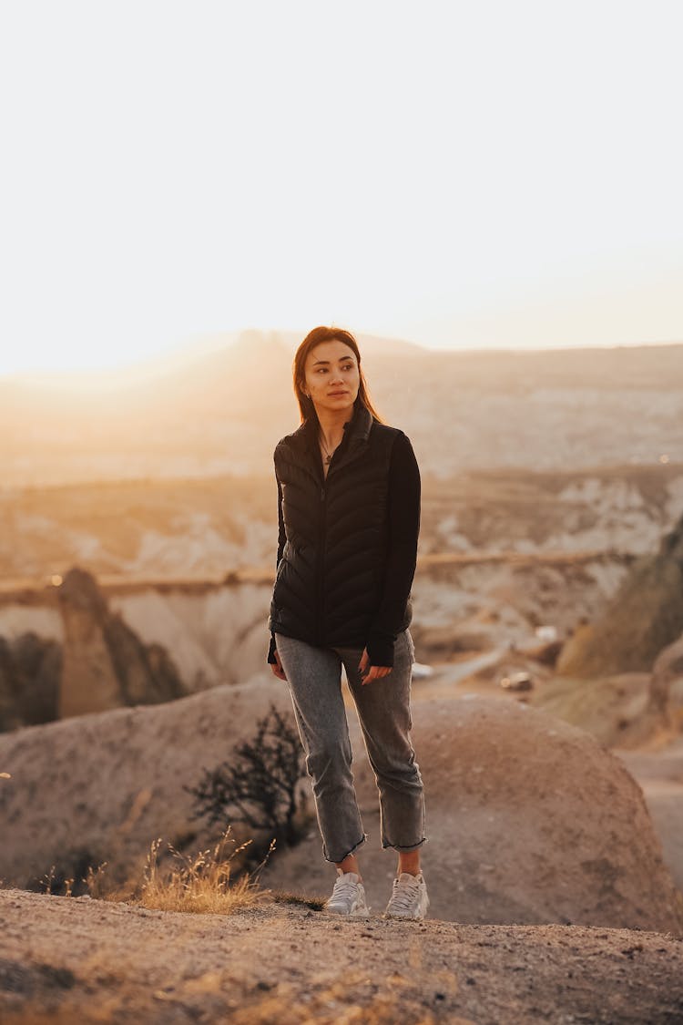 Woman On Mountain Top At Sunrise