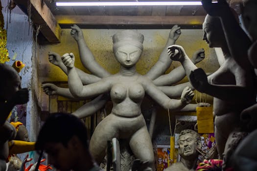 A clay sculpture of Goddess Durga being made in a Kolkata workshop, capturing cultural craftsmanship.