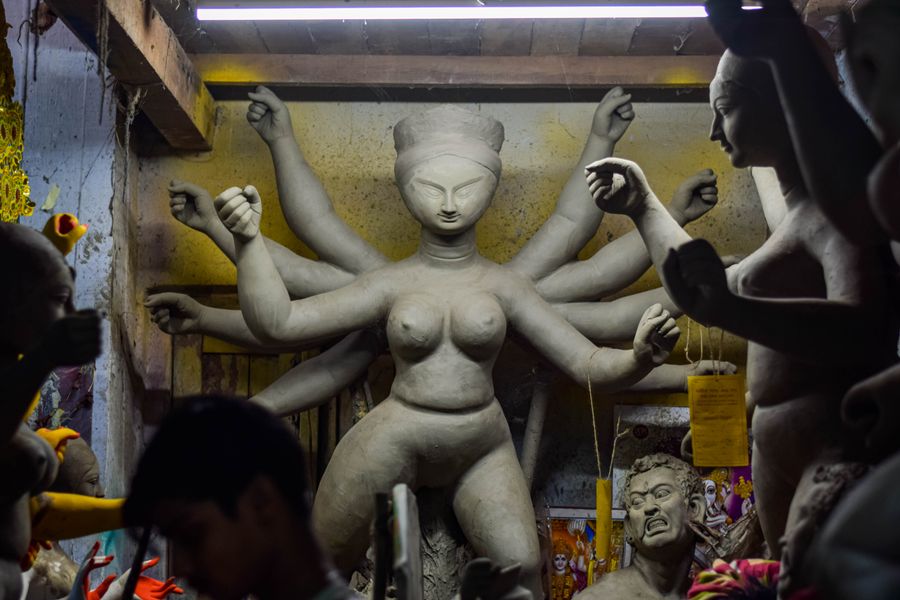 Durga idol being shaped from clay in a Kumartuli workshop