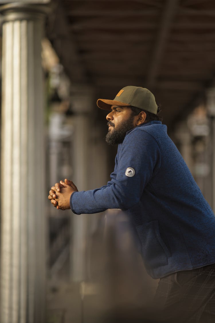 A Man With A Green Cap Thinking