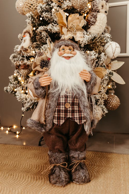 Santa Claus Figurine Beside Gold and White Baubles