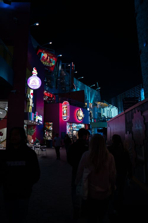 Buildings with Neon Advertising on Night Street