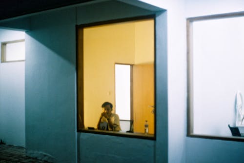 Free Man Sitting at Window in Modern Minimalist House  Stock Photo