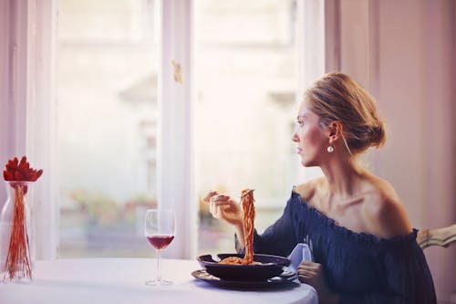 吃面食时坐在椅子上的女人