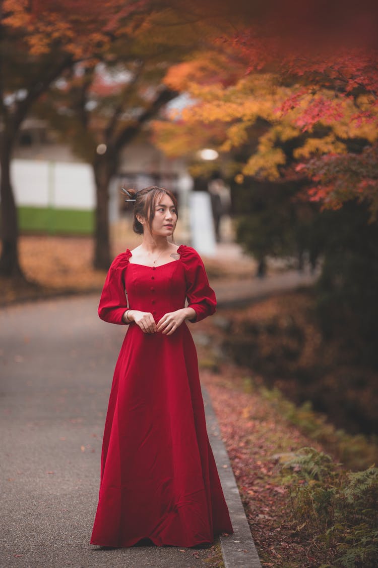 Woman In Red Dress Walking On Road