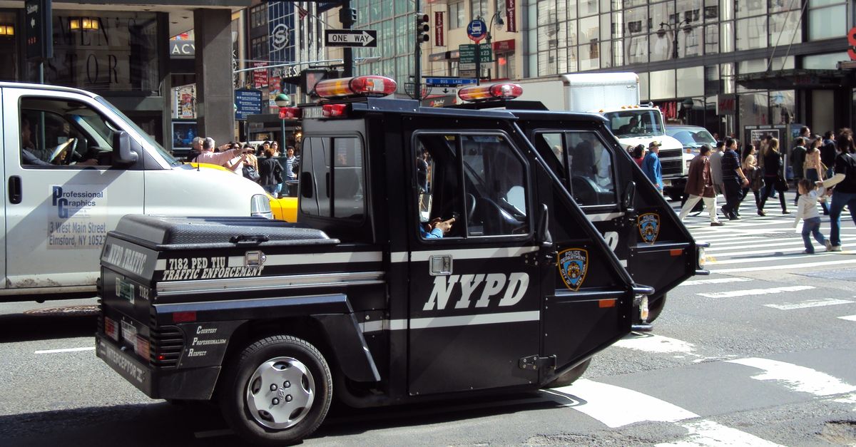 NYPD traffic enforcement vehicle patrolling busy New York City streets.