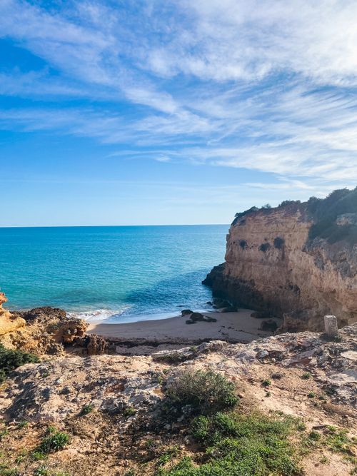 Free Explore the stunning rocky coastline and secluded beach cove in Porches, Algarve, Portugal. Stock Photo