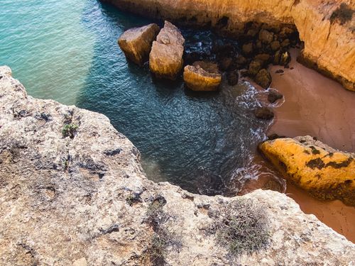 Free A stunning view of the rocky coastline in Lagos, Portugal, showcasing dramatic cliffs and turquoise waters. Stock Photo