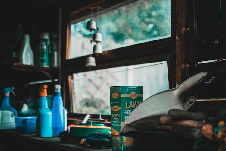 Green Lawn Box Beside Bottles And Window