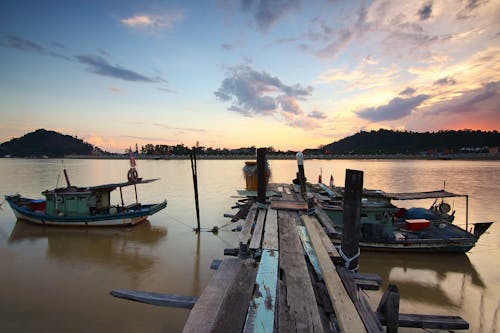 Boat Near Brown Wooden Dock on River