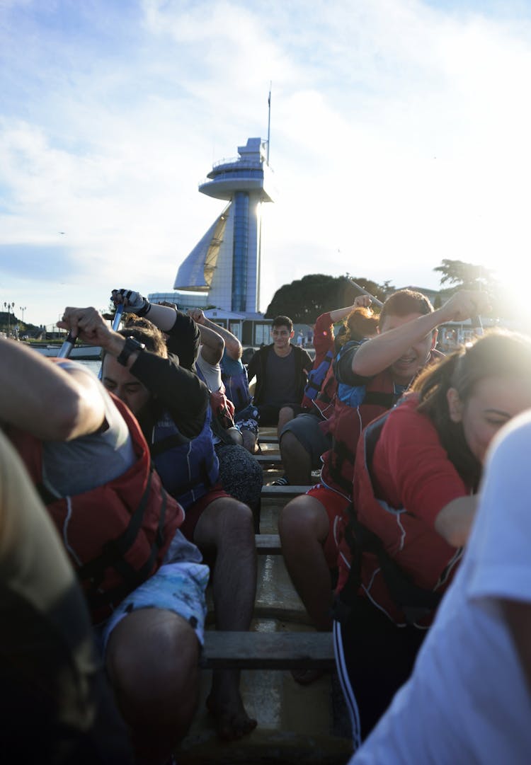 Group Of People Riding And Paddling A Boat