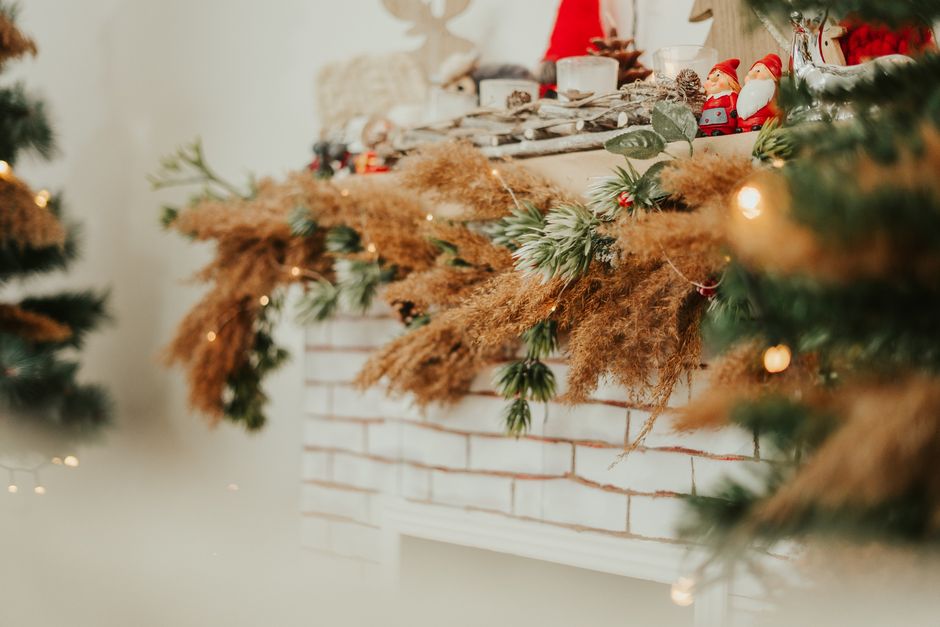 Warm and cozy Christmas fireplace adorned with natural and festive decorations creating a holiday ambiance.