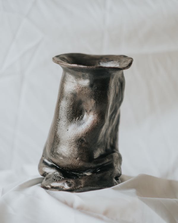 Metallic Clay Vase on White Fabric Background