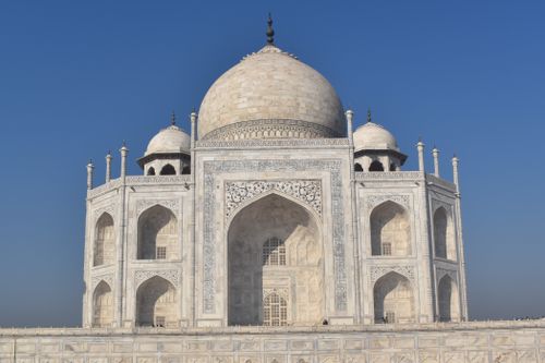 Free Stunning view of the Taj Mahal's iconic domes and facade against a deep blue sky. Stock Photo
