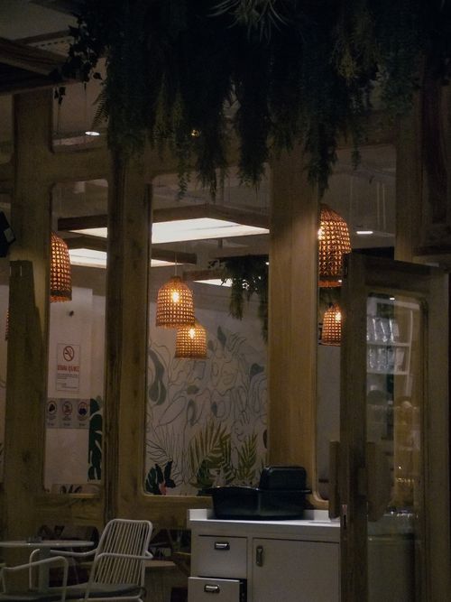 Free Inviting cafe interior with wooden furniture and warm lighting creating a cozy atmosphere. Stock Photo