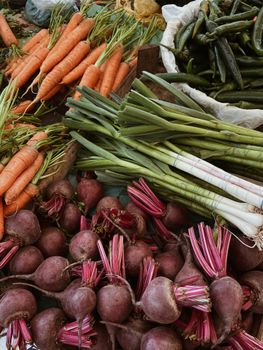 A variety of fresh vegetables including carrots, beetroots, and leeks on a market stall.. variety, fresh, vegetables