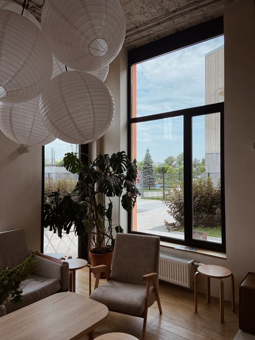 Free A serene modern interior space with large windows, plants, and stylish furniture. Stock Photo