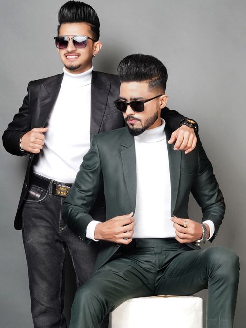 Free Two fashionable men wearing sunglasses and suits posing confidently. Stock Photo