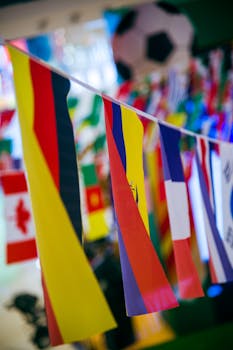 Vibrant international flags hanging indoors with a soccer theme backdrop.
