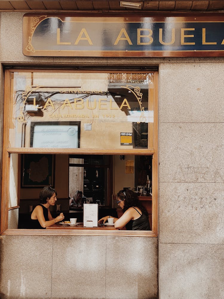 Two Women Eating On The Restaurant 