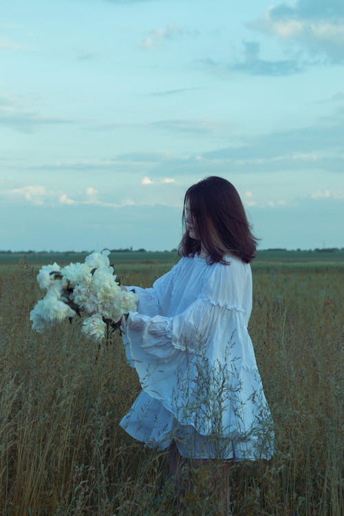 Person Holding White Flowers