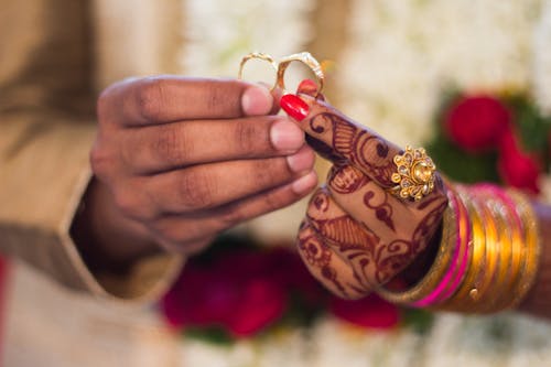 Free Man and Woman Holding Wedding Rings Stock Photo