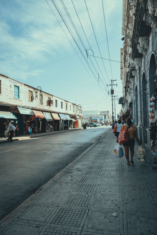Free A lively street market scene featuring historic buildings and people exploring shops. Stock Photo
