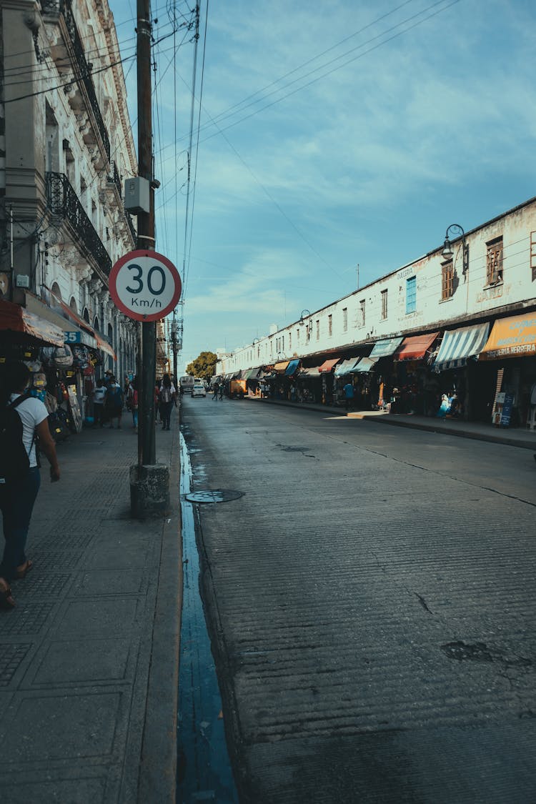 People Walking On Street Sidewalk Of A Public Market