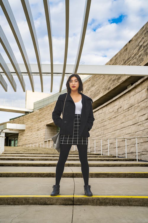 Beautiful Woman in Black Blazer Standing on the Stairs