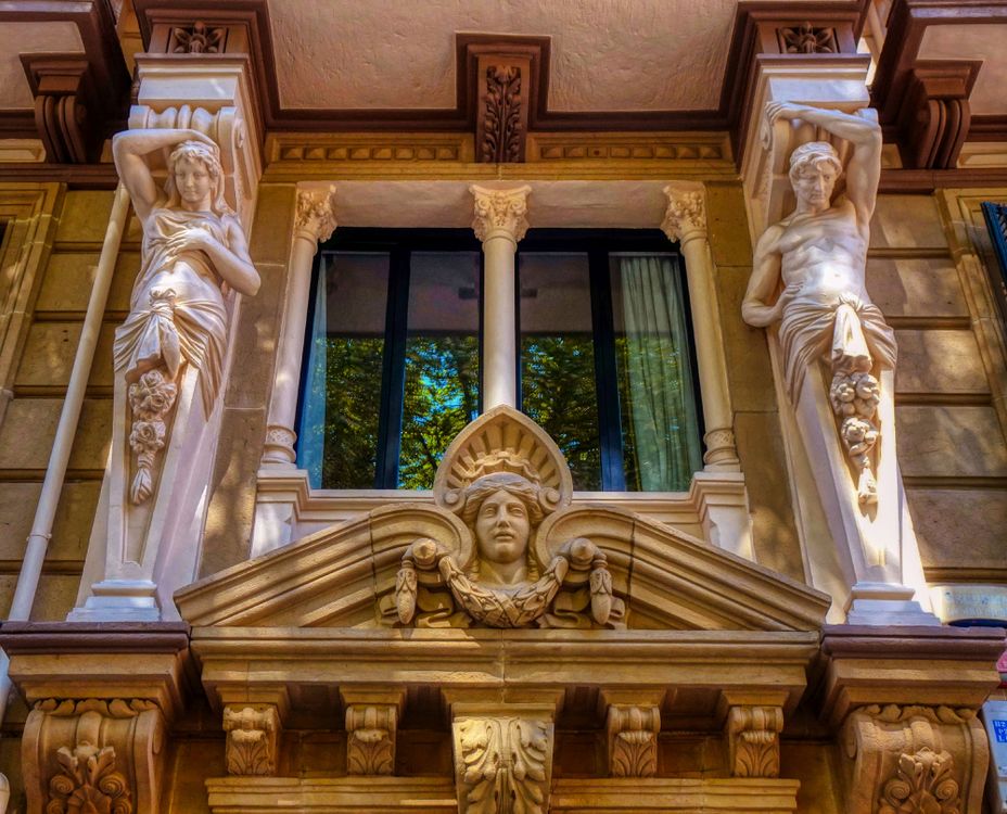 Statues Around a Glass Window · Free Stock Photo