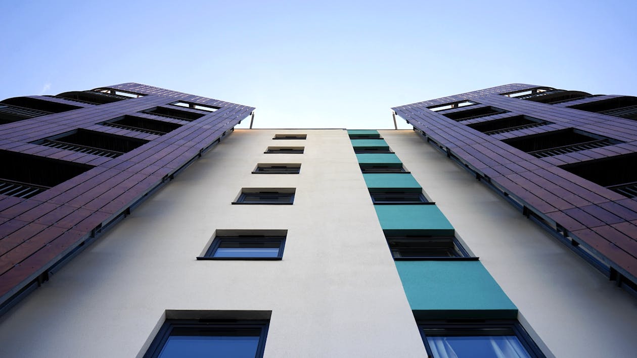 Free Low Angle Photography Of White And Purple Concrete Building Stock Photo