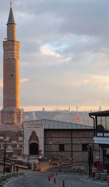 Beautiful view of Ankara's skyline with a historic minaret at sunset, depicting a blend of tradition and modernity.