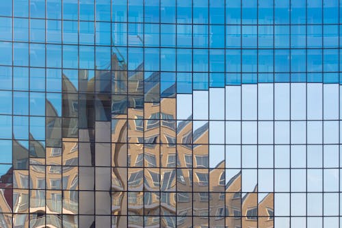 Glass Building Facade with a Building Reflection 