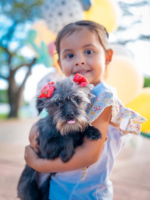 Girl Holding a Dog