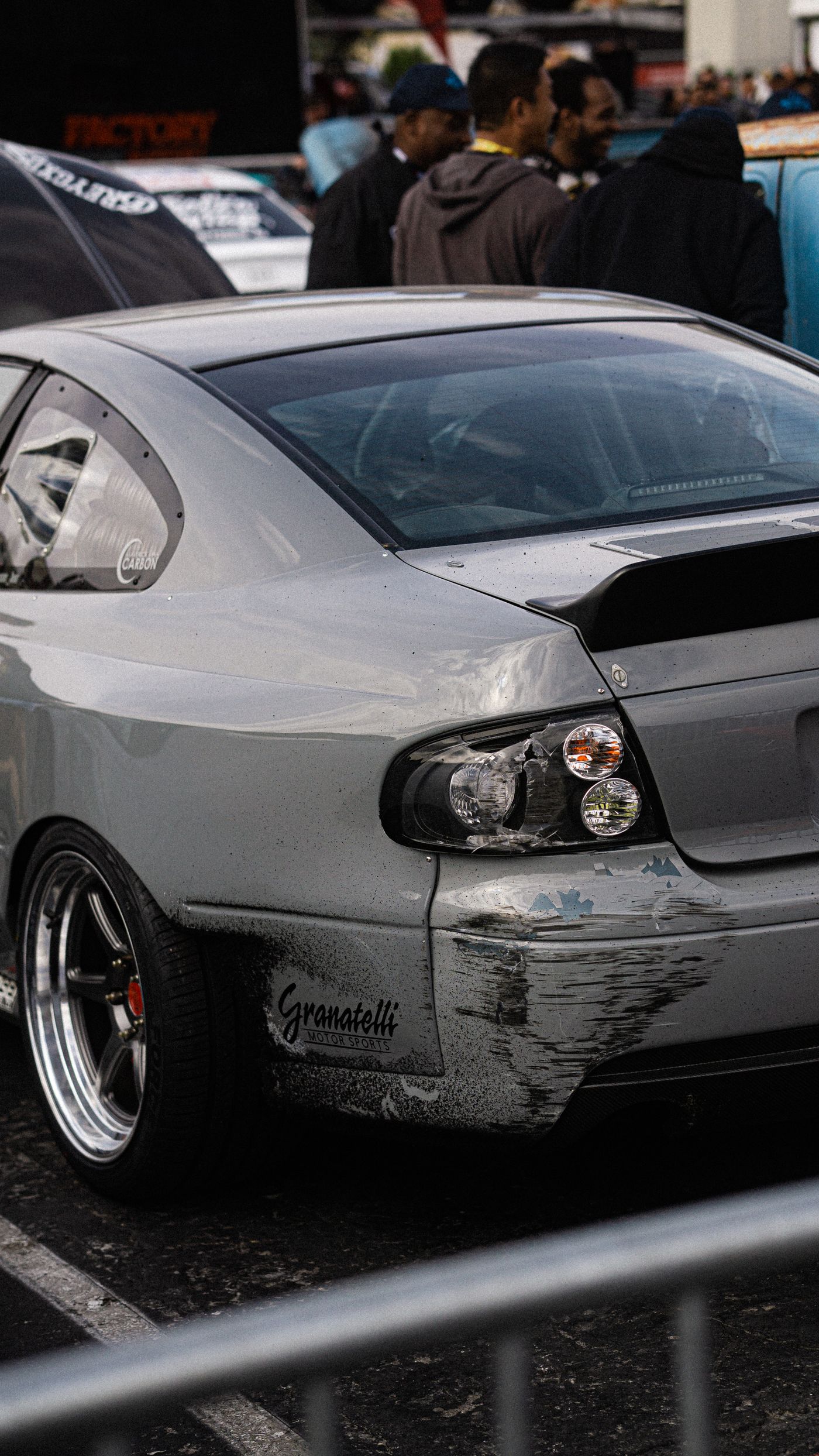 Rear quarter panel and bumper showing visible collision damage for assessment